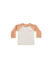Load image into Gallery viewer, Beige baby rash-guard shirt with orange sleeves.