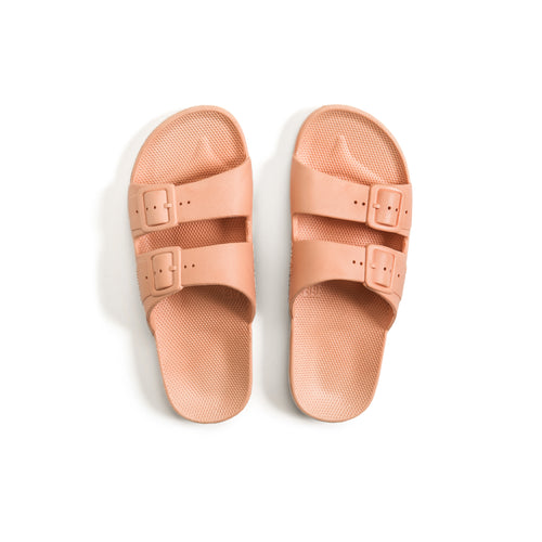 Women's two strap pastel orange sandals with fixed buckles.