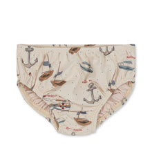 Load image into Gallery viewer, Beige coloured baby swim bloomers featuring an anchor, boat, and sailboat all over print. 
