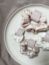 Load image into Gallery viewer, Satin baby scrunchie featuring a baby pink.
