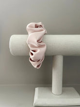 Load image into Gallery viewer, Satin baby scrunchie featuring a baby pink.
