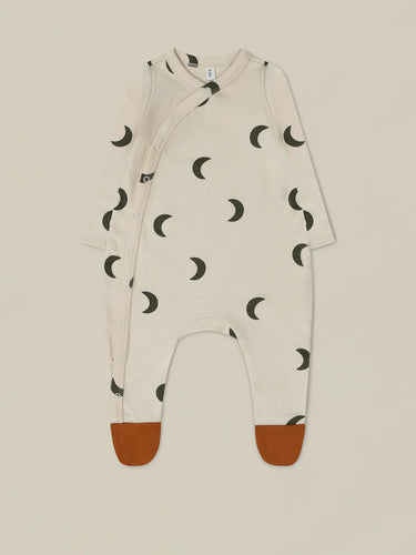 Organic Cotton beige baby onesie with contrast rust feet attached and a dark blue moon print all over. 