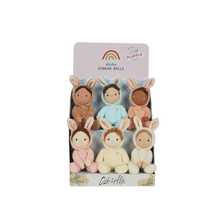 Load image into Gallery viewer, Dinky Dinkum fluffle family featured on a cardboard stand. The set included six dolls featuring a pink, cream, white, peach, blue, and beige doll.
