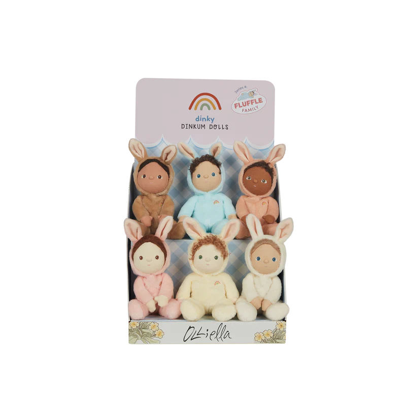 Dinky Dinkum fluffle family featured on a cardboard stand. The set included six dolls featuring a pink, cream, white, peach, blue, and beige doll.