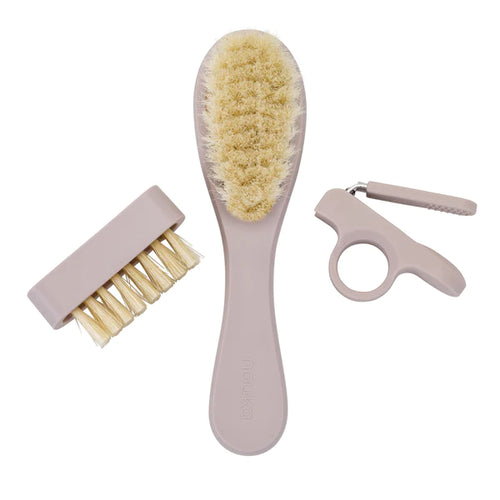 Purple coloured baby grooming kit including a hairbrush, clippers, and nail brush.