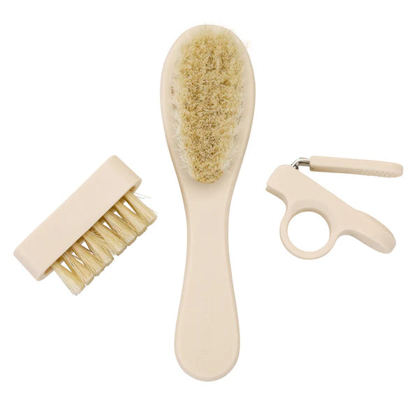 Baby grooming kit including a hairbrush, clippers, and a nail brush. 
