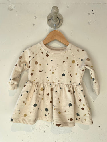Beige long sleeve sweater dress with a 'paint' splat print all over. 