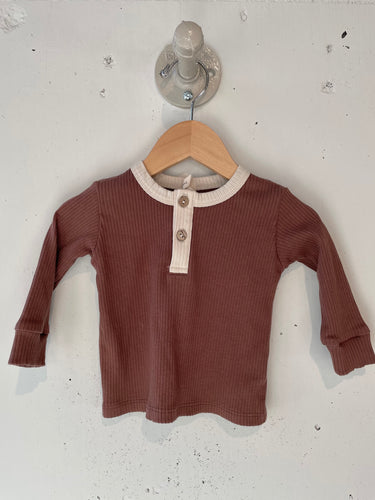 Red and Brown Long sleeve tee with buttons in the middle. 