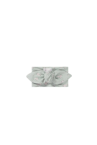 Baby blue headband with a white floral all over print.