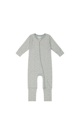 Baby blue jumpsuit with zipper from top to feet. White floral print over baby blue colour. 