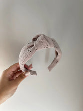 Load image into Gallery viewer, Mauve lace fabric on a structured headband featuring a knot at the top. 
