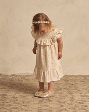 Load image into Gallery viewer, A-line neckline featuring a scoop ruffle and a ruffle at the bottom. The dress is featured in a pale yellow.
