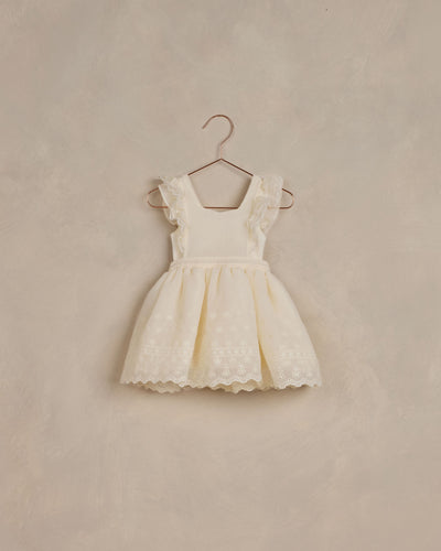 Ivory dress with ruffle sleeves and a vintage inspired skirt featuring lace.