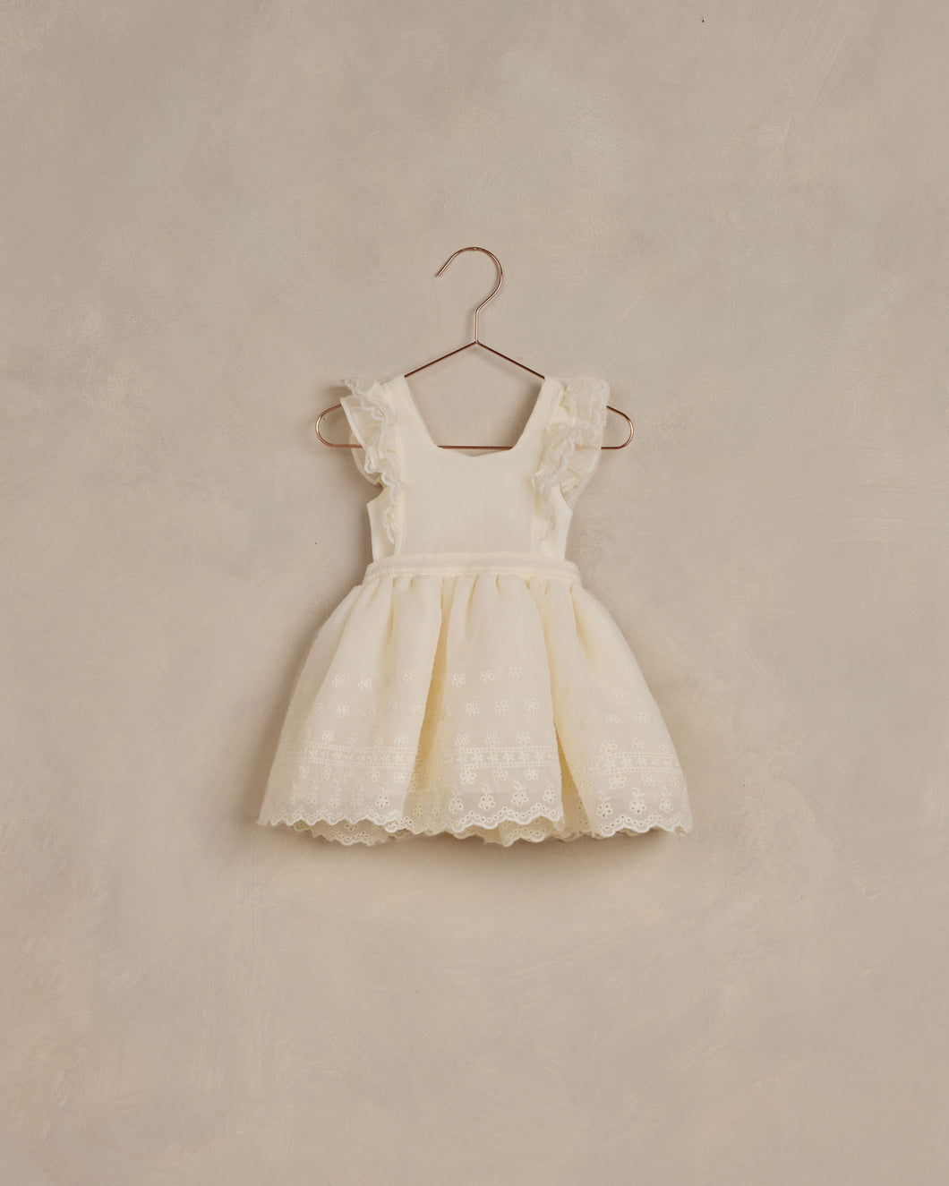 Ivory dress with ruffle sleeves and a vintage inspired skirt featuring lace.