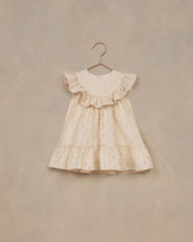 Load image into Gallery viewer, A-line neckline featuring a scoop ruffle and a ruffle at the bottom. The dress is featured in a pale yellow. 
