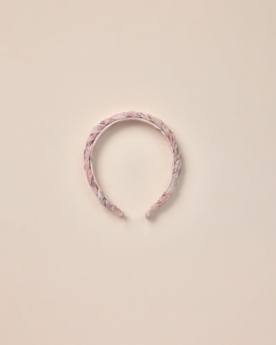 Braided headband in a pink floral all over print  on an ivory base. 