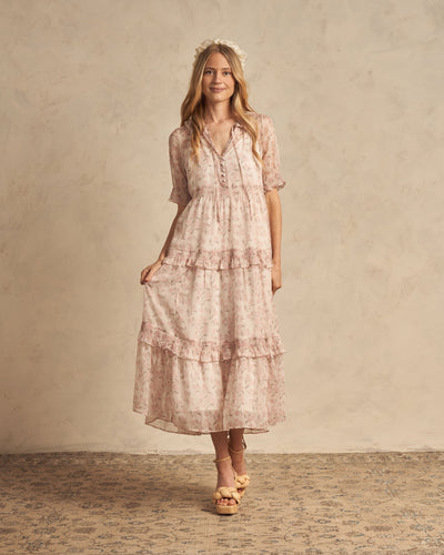 This dress has a soft flower print, cute short sleeves, and dainty front ties featuring a french hydrangea pink all over print on an ivory base. 