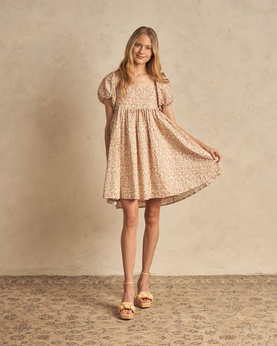 Baby doll dress with puffy sleeves and a gathered waist. This dress is featuring the wildflower print with pinks, greens, and beiges. 