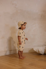 Load image into Gallery viewer,  Beige organic terry cotton romper with a dark blue moon print all over.
