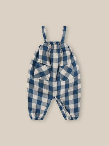 Organic Cotton blue and white gingham printed jumpsuit with two pockets on the front. 