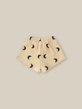 Load image into Gallery viewer, Beige organic terry cotton shorts with a dark moon all over print.
