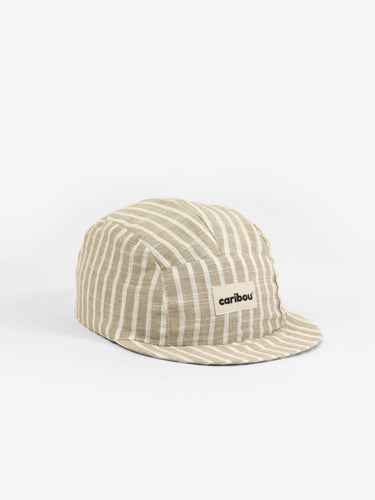 Baby cap featuring a beige and cream striped pattern and a five panel design. 