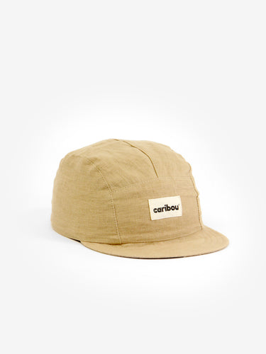 Baby cap featuring a beige colour and five panel design. 