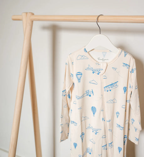 Beige baby sleeper with a planes all over print.