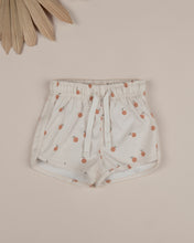 Load image into Gallery viewer, Beige coloured baby swim shorts featuring an oranges all over print.
