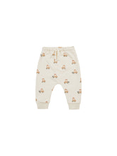 Load image into Gallery viewer, Beige coloured baby sweatpants with a tractor all over print. 
