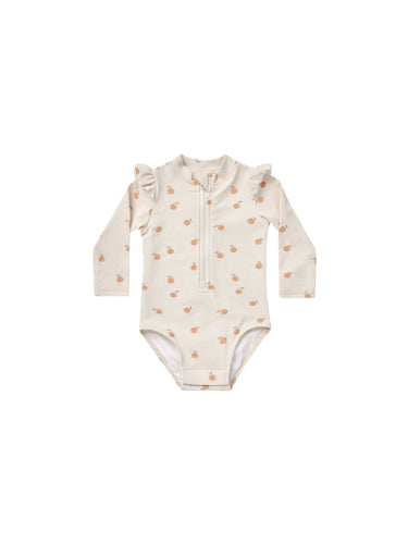 Beige coloured baby one piece rash guard with zipper on the front and ruffles on the shoulders. This rash-guard is featuring an oranges all over print. 