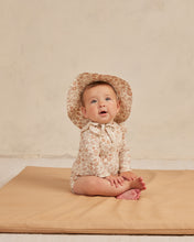 Load image into Gallery viewer, Beige coloured baby one piece rash guard with zipper on the front and ruffles on the shoulders. This rash-guard is featuring a floral print.
