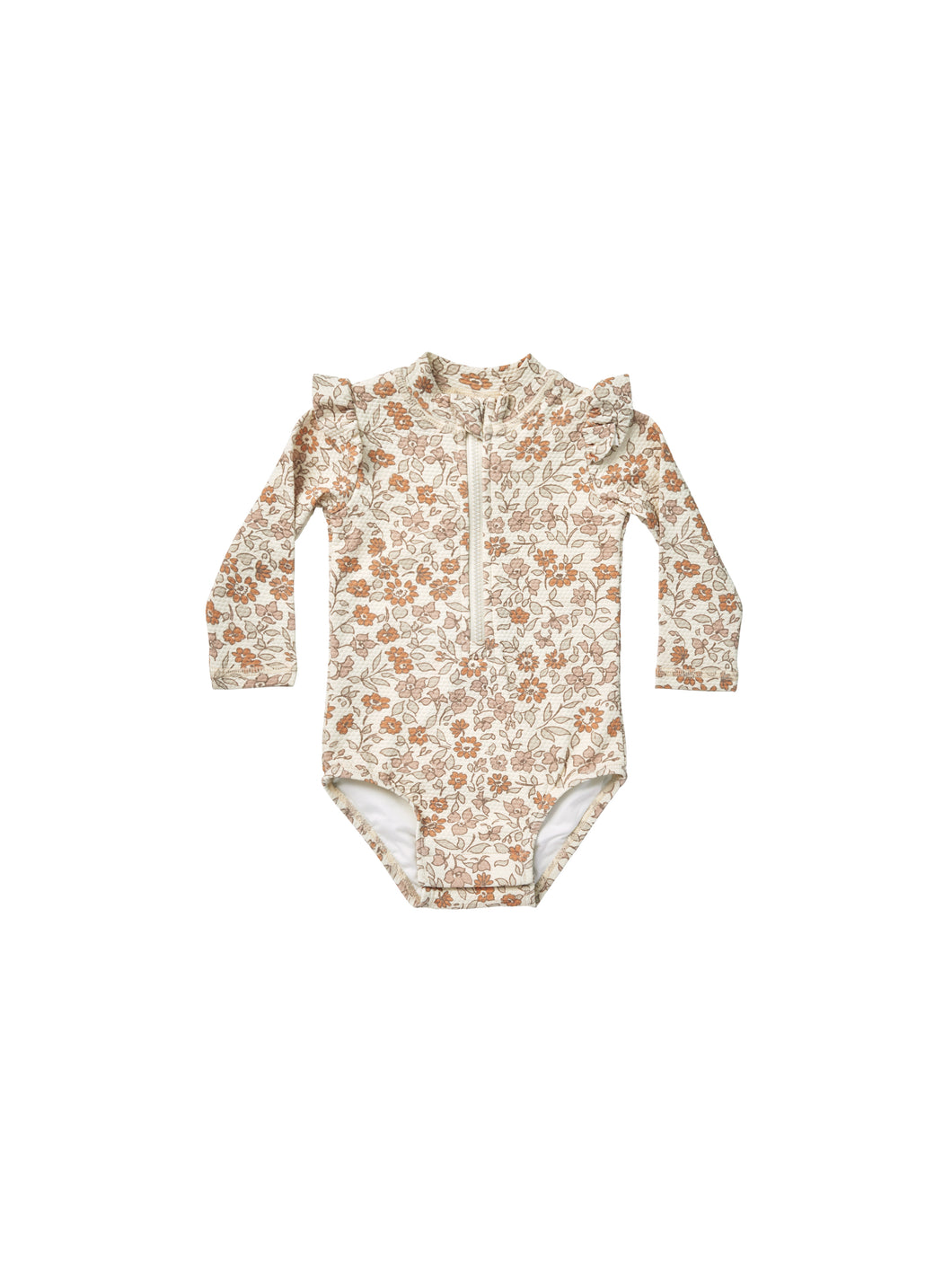 Beige coloured baby one piece rash guard with zipper on the front and ruffles on the shoulders. This rash-guard is featuring a floral print.