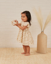 Load image into Gallery viewer, Beige coloured baby dress with ruffle sleeves and three tiers on the skirt. This dress features an oranges all over print.
