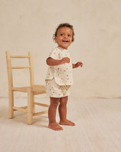 Load image into Gallery viewer, Beige baby tee and matching shorts on a woven fabric and an all over orange print.
