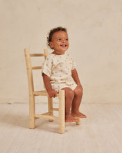Load image into Gallery viewer, Beige baby tee and matching shorts on a woven fabric and an all over orange print.
