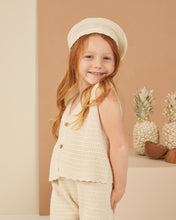 Load image into Gallery viewer, This sleeveless knit vest features buttons down the front and scalloped hem. Featured in a beige.
