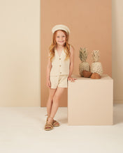 Load image into Gallery viewer, This sleeveless knit vest features buttons down the front and scalloped hem. Featured in a beige.
