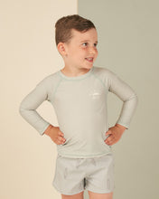 Load image into Gallery viewer, Long Sleeve rash guard in a seafoam colour. This rash guard also features a R + C along with a half sun in the top left corner of front.
