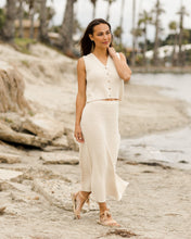 Load image into Gallery viewer, This crochet knit midi skirt is oh-so-comfy and perfect for day in the sun. Features include an elastic waistband, mini liner, side slit, and scalloped hem. Featured in natural.
