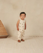 Load image into Gallery viewer, Cream coloured baby jumpsuit with a sailboat all over print.
