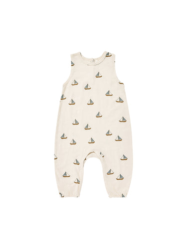 Cream coloured baby jumpsuit with a sailboat all over print. 