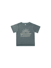Load image into Gallery viewer, Indigo organic cotton tee featuring a surfboard, waves, and the sun as a graphic. 
