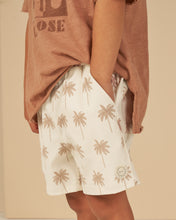 Load image into Gallery viewer, Cream children&#39;s swim shorts with beige palm tree all over print.
