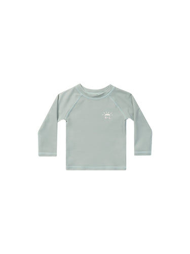 Long Sleeve rash guard in a seafoam colour. This rash guard also features a R + C along with a half sun in the top left corner of front. 