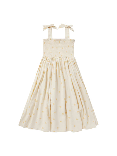 The soft and breathable linen, smocked bodice, tie sleeves, and full skirt on a beatiful beige colour and yellow polka dots. 
