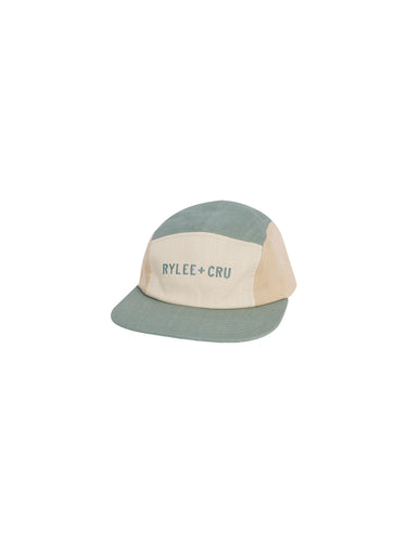 Five panel ball cap featuring a pale teal, beige, and ivory colour block pattern. Rylee + Cru is featured on the front. 