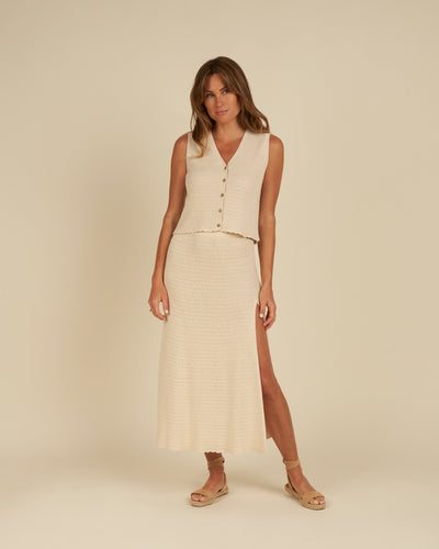 This crochet knit midi skirt is oh-so-comfy and perfect for day in the sun. Features include an elastic waistband, mini liner, side slit, and scalloped hem.  Featured in natural.