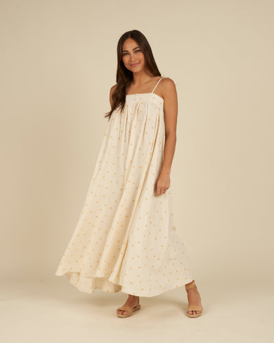 This woven linen maxi dress is perfect for days at home or days on the go. Featuring tie spaghetti straps, two buttons on front, smocking on back, and an a-line silhouette.  Featuring a yellow polka dot all over print on ivory.