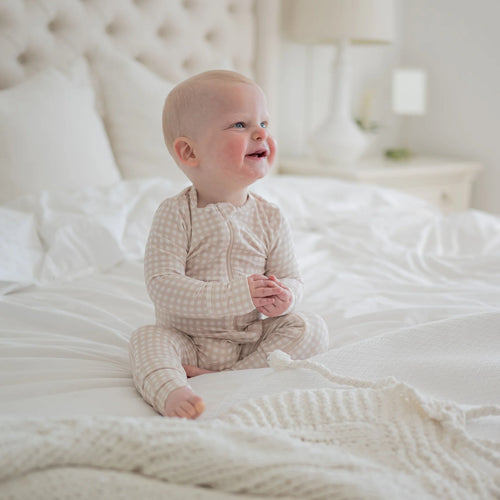 Baby sleepwear in a bamboo fabric and oat gingham print.